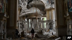 Church personnel inspect damage inside the Spaso-Preobrazhensky (Lord's Transfiguration) Cathedral in Odesa, Ukraine, July 23, 2023, following Russian missile attacks.