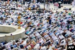 Muslim pilgrims pray around the Kaaba, Islam's holiest shrine, at the Grand Mosque in the holy city of Mecca at the end of the annual hajj pilgrimage, June 18, 2024.