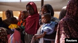 FILE - Women and babies wait at the Zamzam displacement camp, home to 400,000 people, in North Darfur, Sudan, in January 2024. (Medecins Sans Frontieres via Reuters)