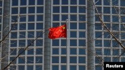 A Chinese flag flutters outside the Chinese foreign ministry in Beijing, China, Feb. 24, 2022.