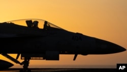 A fighter jet maneuvers on the deck of the USS Dwight D. Eisenhower in the Red Sea, June 11, 2024. 