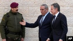 PLO Secretary General Hussein al-Sheikh, center, welcomes U.S. Secretary of State Antony Blinken, right, before his meeting with Palestinian President Mahmoud Abbas in the West Bank town of Ramallah, Feb. 7, 2024.