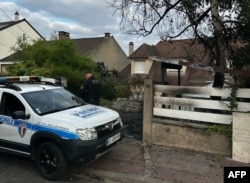 A municipal police officer stands in front of the damaged home of the Mayor of l'Hay-les-Roses Vincent Jeanbrun, on July 2, 2023, after rioters rammed a vehicle into the building injuring the mayor's wife and one of his children overnight.