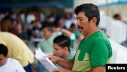 A man takes part in a referendum that asks voters to support mostly security-related questions to fight rising violence, in Nobol, Guayas province, Ecuador, April 21, 2024. 
