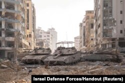 Israeli military vehicles take position in the Gaza Strip amid the ongoing ground operation of the Israeli army against Palestinian Islamist group Hamas, Nov. 12, 2023.