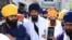 FILE - 'Waris Punjab De' chief Amritpal Singh (C) pays his respect at the Golden Temple in Amritsar on March 3, 2023. 
