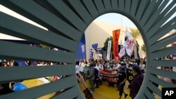 Activists demonstrate for climate justice and a cease-fire in the Israel-Hamas war at the COP28 United Nations Climate Summit in Dubai, United Arab Emirates, Dec. 9, 2023.