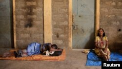 FILE - People displaced due to the fighting rest outside their shelter at the Abi Adi camp for internally displaced in Abi Adi, Tigray region, Ethiopia, June 24, 2023.