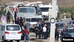People, including Armenian service members and refugees from Nagorno-Karabakh region, gather at a checkpoint in the village of Kornidzor, Armenia, Sept. 24, 2023. 
