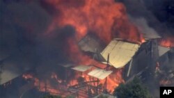 This image made from video shows home engulfed in flames outside Perth, Australia, Dec. 21, 2023.