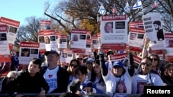 FILE - Jewish Americans and supporters of Israel hold signs as they gather in solidarity with Israel and protest against antisemitism during a rally on the National Mall in Washington, Nov. 14, 2023.