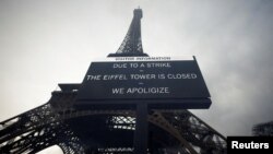 A sign accouncing the closing of the Eiffel Tower due to a strike is seen in front of the 19th century landmark in Paris, France, Feb. 19, 2024.