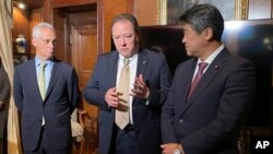 US Ambassador to Japan Rahm Emanuel, left, Ukraine Ambassador to Japan Sergey Korsunsky, center, and acting secretary general of the governing Liberal Democratic Party Seiji Kihara speak to the media in Tokyo, Dec. 7, 2023. 