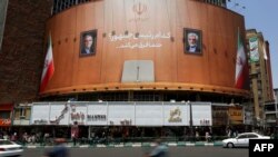 Motorbikes ride past an electoral banner bearing images of moderate candidate Masoud Pezeshkian, left, and ultraconservative candidate Saeed Jalili, and the Persian script: 'Which president? It certainly makes a difference,' in Tehran on July 4, 2024. 