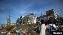People look at damages caused by Hurricane Otis in Acapulco, Mexico, Oct. 26, 2023.