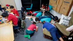 Students works on their memory books during the last week of classes at Frye Elementary School in Chandler, Arizona, May 23, 2023.