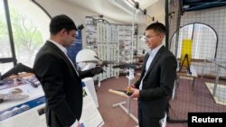 Dr. Mostafa Hassanalian, New Mexico Tech, working with a student on taxidermy bird drone