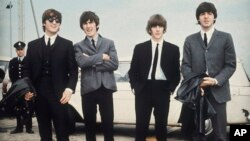FILE - John Lennon, George Harrison, Ringo Starr and Paul McCartney arrive in Liverpool, England, on July 10, 1964, for the premiere of "A Hard Day's Night." 