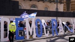 Protestors demand democracy during the visit of Israeli Prime Minister Benjamin Netanyahu to 10 Downing Street in London, March 24, 2023.