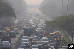 FILE - Commuters drive amidst morning haze and toxic smog in New Delhi, India, Wednesday, Nov. 17, 2021. (AP Photo/Manish Swarup)