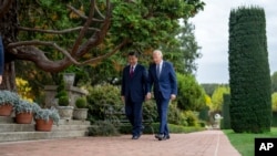 President Joe Biden and China's President President Xi Jinping walk in the gardens at the Filoli Estate in Woodside, California, Nov, 15, 2023, meeting on the sidelines of the Asia-Pacific Economic Cooperative forum. (Doug Mills/The New York Times via AP)