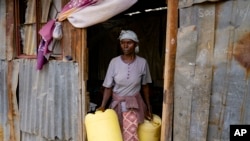 FILE - Joyce Ngui heads to fetch groundwater in Athi River, Machakos county, Kenya, Oct. 17, 2023. 