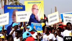 Des manifestants de l'opposition sénégalaise brandissant des photos de l'ancien ministre Karim Wade lors d'une marche pour exiger la transparence lors des élections, à Dakar, le 29 novembre 2018. (Archives)