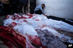 Palestinians mourn relatives killed in the Israeli bombardment of the Gaza Strip at a hospital morgue in Rafah, Feb. 12, 2024. The Israeli military said early Monday that it had rescued the two hostages from captivity in the Gaza Strip.