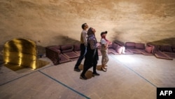 People visit the Safavid-era (1501-1736) Bagh Gandom Ab-Anbar (cistern) in Iran's central city of Yazd on July 3, 2023.