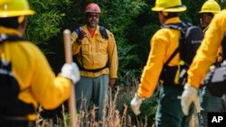 Wildland firefighter instructor James Klungness-Mshoi, center, gives instructions to students during a wildland firefighter training, June 9, 2023, in Hazel Green, Alabama.