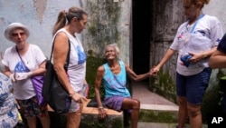 Municipal health workers inspect the Tabajaras favela for standing water where Aedes aegypti mosquitoes can breed, in an effort to stop the spread of dengue in the Copacabana neighborhood of Rio de Janeiro, Brazil, Feb. 7, 2024.