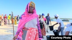 A returned internally displaced person, or IDP, receives a kit from the International Committee of the Red Cross in Montepuez, Cabo Delgado. (International Committee of the Red Cross)