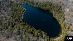 An aerial view of Crawford Lake, near Milton, Ontario, April 12, 2023. Scientists believe the lake's well-preserved sediment layers serve as a reference for a proposed new geological chapter in Earth history, defined by changes wrought by human activity.