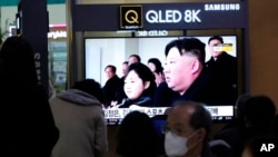 FILE - A TV screen shows a file image of North Korean leader Kim Jong Un and his daughter, Kim Ju Ae, during a news program at the Seoul Railway Station in Seoul, South Korea, Feb. 18. 2023.
