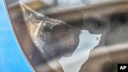 A survivor of latest tragical shipwreck looks out from a bus that will transfer him to Athens with other migrants and refugees at the port of Kalamata, Greece, June 16, 2023.