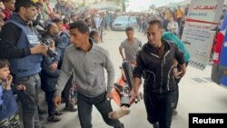 Palestinians wounded in Israeli strikes are rushed into Nasser hospital in Khan Younis in the southern Gaza Strip, Dec. 7, 2023.