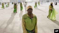 Cleaners line up in front of pilgrims after they cast stones at a pillar in the symbolic stoning of the devil, the last rite of the annual Hajj pilgrimage, in Mina near Mecca, Saudi Arabia, June 28, 2023.