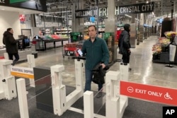 Stuart Dryden leaves a grocery store on Feb. 21, 2024, in Arlington, Va.