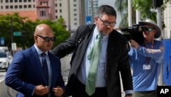 Walt Nauta, left, a valet to former President Donald Trump who is charged with helping the ex-president hide classified documents the Justice Department wanted back, arrives at the James Lawrence King Federal Justice Building in Miami, Thursday, July 6, 2023. 