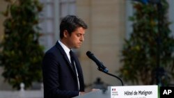 FILE - French Prime Minister Gabriel Attal delivers a speech after the second round of the legislative elections, July 7, 2024 in Paris. President Macron refused his resignation on Monday, asking him to remain temporarily as the head of the government.