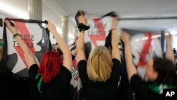 Abortion rights activists react after Poland's parliament voted to continue work on proposals to liberalize Poland's strict abortion law, in Warsaw, Poland, on April 12, 2024. 