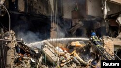 A firefighter works at a site of an apartment building heavily damaged by a Russian missile strike, amid Russia's attack on Ukraine, in Kryvyi Rih, Ukraine, July 31, 2023. (Press service of the State Emergency Service of Ukraine/Handout via Reuters)