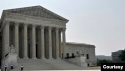 Security officers stand outside the U.S. Supreme Court building in Washington, DC. (Photo by Diaa Bekheet)