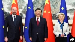 FILE - Chinese President Xi Jinping, center, stands with European Commission President Ursula von der Leyen and European Council President Charles Michel in Beijing, Dec. 7, 2023. China is making efforts to relieve recent tensions between it and the EU.