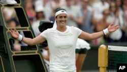FILE- Tunisia's Ons Jabeur celebrates earlier win against Aryna Sabalenka of Belarus during the women's semifinal singles match on day 11 of Wimbledon in London, July 13, 2023