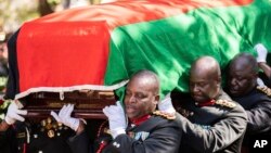 FILE - Pallbearers carry the coffin at the burial service for Malawi's Vice President Saulos Chilima in Nsipe, Malawi, June 17, 2024. 