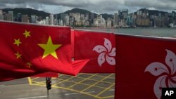 FILE - Chinese and Hong Kong flags mark the 25th anniversary of Hong Kong handover to China, in Hong Kong on June 17, 2022.