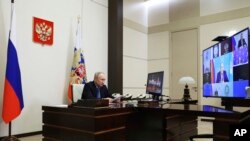 Russian President Vladimir Putin chairs the Security Council meeting via videoconference at the Novo-Ogaryovo State residence outside Moscow, Feb. 13, 2024. (Alexander Kazakov, Sputnik, Kremlin Pool Photo via AP)