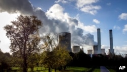 FILE - Steam rises from the coal-fired power plant Niederaussem, Germany, on Nov. 2, 2022. 