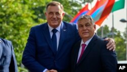 Bosnian Serb leader Milorad Dodik, left, poses with Hungarian Prime Minister Viktor Orban during a welcome ceremony in Banja Luka, Bosnia northwest of Sarajevo, June 22, 2023.